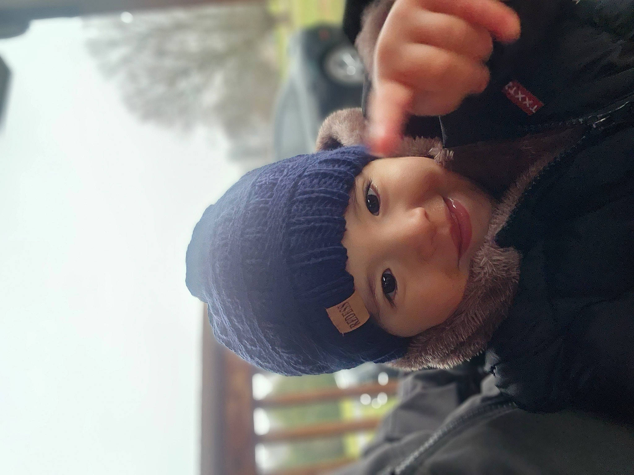 Dante joined the competition — help win amazing prizes! beanie, black_hair, child, denim, elbow, electric_blue, flash_photography, fun, gesture, hat, headwear, lip, nail, person, portrait_photography, sitting, skin, smile, tree, winter