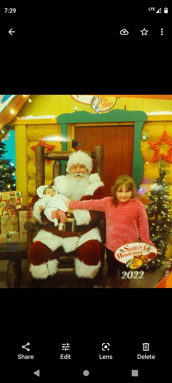 Ava joined the competition — help win amazing prizes! beard, christmas, christmas_decoration, christmas_eve, christmas_ornament, christmas_tree, conifer, door, event, fictional_character, fun, headwear, holiday, holiday_ornament, interior_design, joy, lap, ornament, person, room