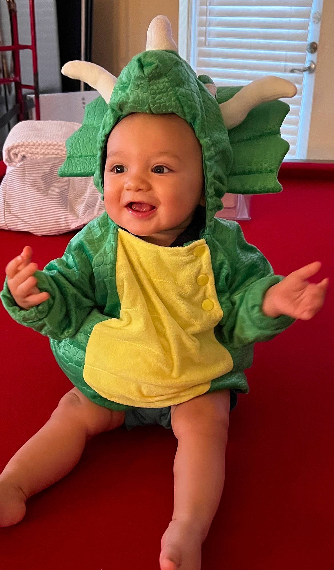 Aiden is registered to the contest to win money with this photo: baby, baby_toddler_clothing, cap, child, costume_hat, eye, face, fun, green, happy, hat, headgear, headwear, human_body, organ, person, pink, skin, sleeve, smile