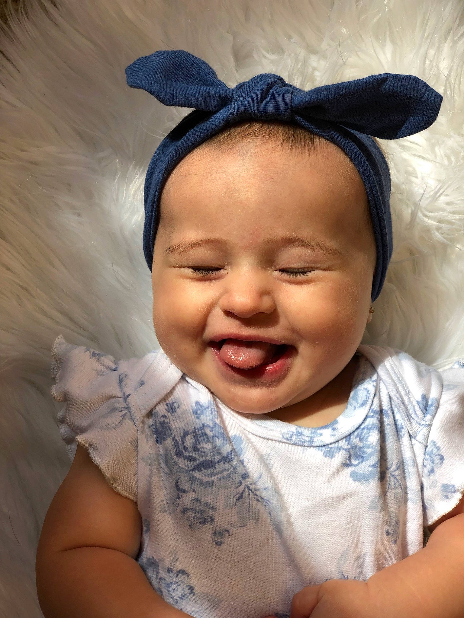 Siena is registered to the contest to win money with this photo: baby, baby_making_funny_faces, cheek, child, ear, face, facial_expression, forehead, hair_accessory, happy, head, headband, headgear, joy, laugh, lip, nose, organ, person, skin