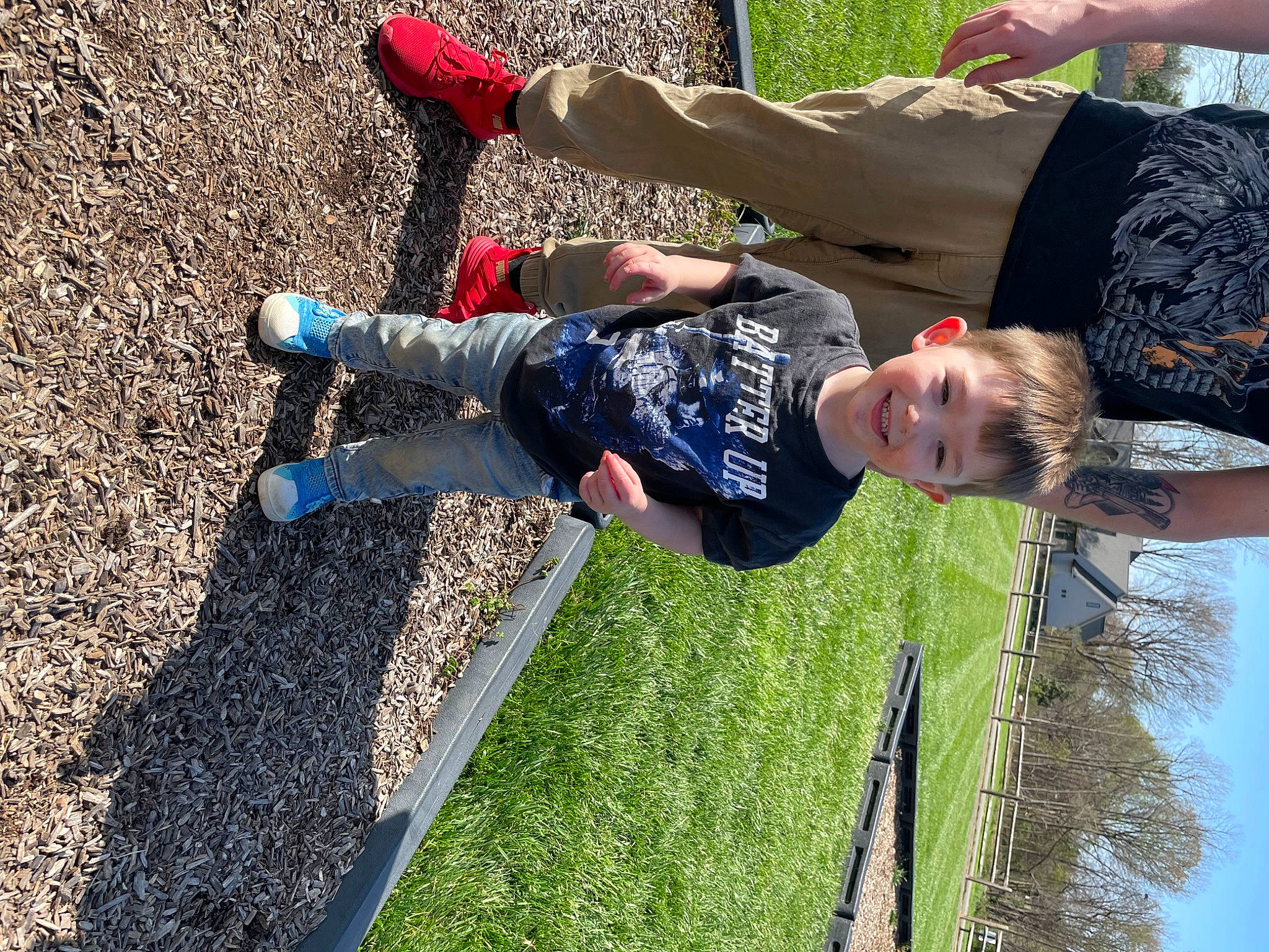 Axel is registered to the contest to win money with this photo: asphalt, child, electric_blue, fun, grass, happy, human_leg, joy, leisure, people_in_nature, person, plant, recreation, shadow, sky, sock, soil, t_shirt, toddler, tree