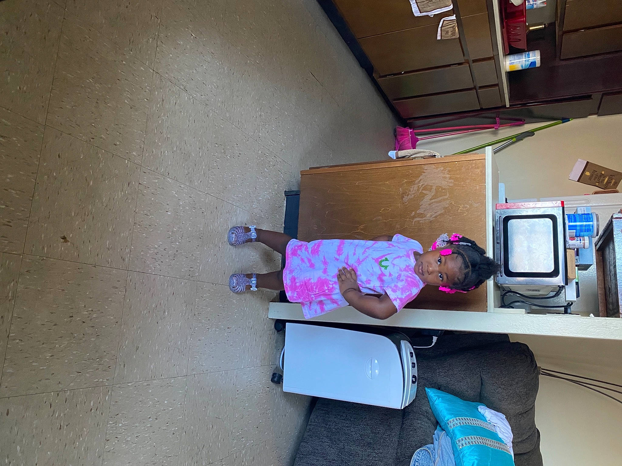 Krystal is registered to the contest to win money with this photo: bag, box, cardboard, computer_desk, computer_monitor, desk, desktop_computer, display_device, flooring, fun, gadget, house, luggage_and_bags, magenta, person, purple, room, shelving, shipping_box, toddler