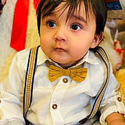 Orhan joined the competition — help win amazing prizes! accessories, baby, bodypart, bowtie, clothing, coat, couch, face, finger, formalwear, furniture, hand, head, pants, person, photography, portrait, shirt, suspenders, tie