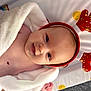 Remmie is registered to the contest to win money with this photo: baby, infant, smiling, face, headwear, antlers, blanket, white_blanket, red, gold, holiday, festive, cute, lying_down, skin, cheeks, eyes, indoors, soft_texture, colorful
