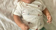 Aemilius joined the competition — help win amazing prizes! baby, child, infant, portrait, lying_down, bed, blanket, indoors, face, eyes, open_mouth, curious, clothing, onesie, pants, green_clothing, arms, hands, photography, home