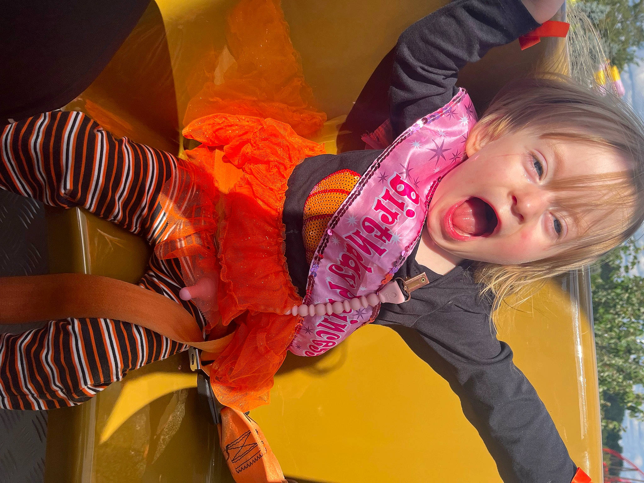 Renesmay is registered to the contest to win money with this photo: child, comfort, fun, happy, human_leg, leisure, magenta, pattern, person, plant, sitting, smile, surprise, toddler, tree