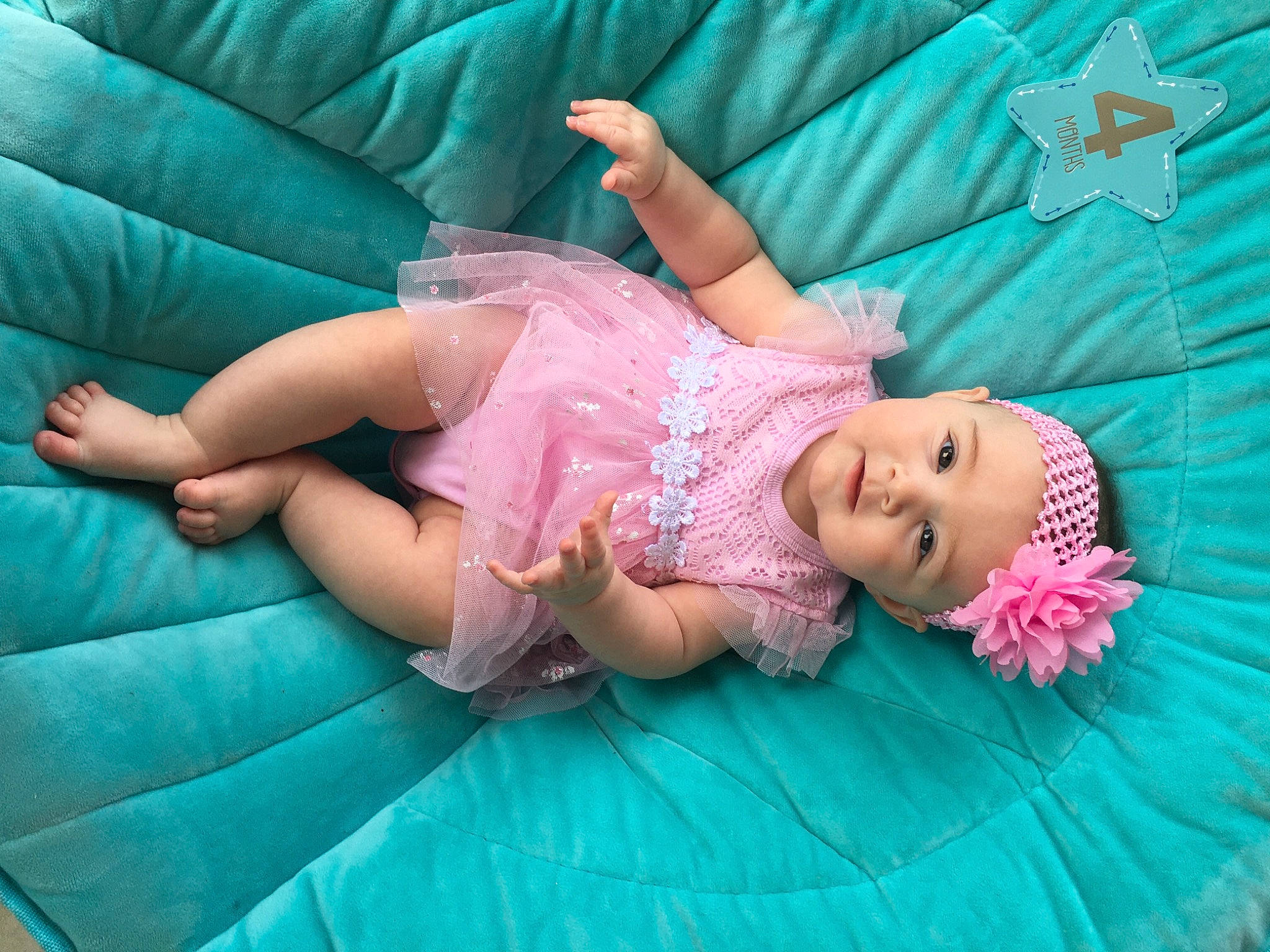 Harlee is registered to the contest to win money with this photo: arm, baby, baby_toddler_clothing, comfort, eye, grass, green, hair, happy, head, headwear, leg, leisure, mammal, person, pink, purple, skin, smile, thigh