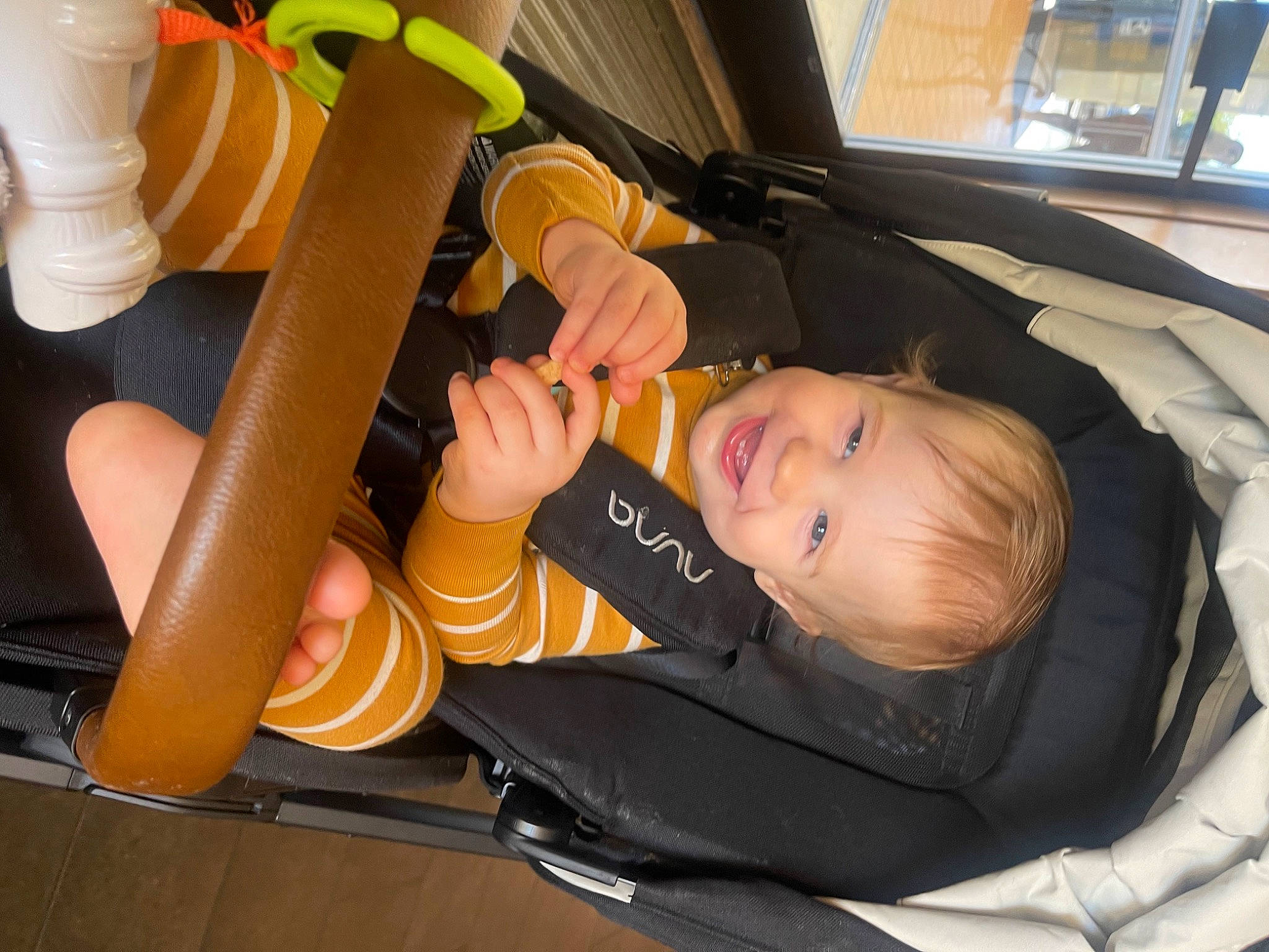 Bear is registered to the contest to win money with this photo: auto_part, automotive_wheel_system, baby, baby_carriage, baby_products, baby_safety, baby_toddler_clothing, car_seat, chair, child, comfort, finger, fun, joy, nail, orange, person, sitting, smile, thumb