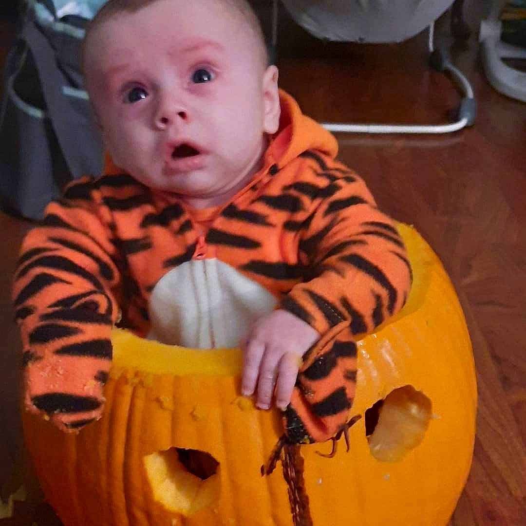 Carlo is registered to the contest to win money with this photo: baby, calabaza, cheek, child, mouth, person, pumpkin, surprise, toddler