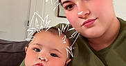 Benji joined the competition — help win amazing prizes! baby, casual, child, couch, cute, doodle, drawing, ears, face, family, home, indoor, nose, onesie, person, playful, portrait, relaxed, together, woman