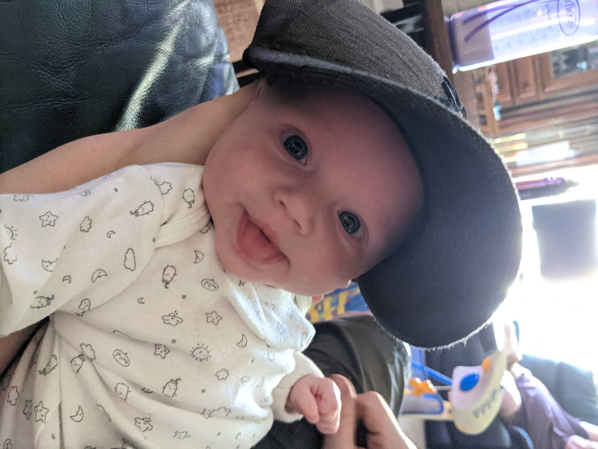 Adella is registered to the contest to win money with this photo: baby, baby_products, baby_toddler_clothing, cap, cheek, child, facial_expression, gesture, happy, hat, headgear, headwear, lip, mouth, nose, people, person, skin, sleeve, smile