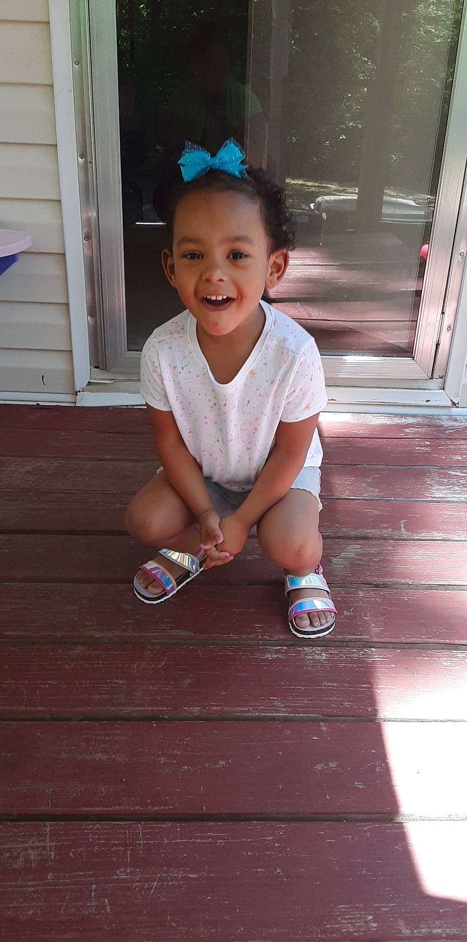 Jocelyn is registered to the contest to win money with this photo: arm, baby_toddler_clothing, child, face, floor, flooring, fun, happy, hardwood, human_leg, joy, leg, person, skin, sleeve, smile, sneakers, standing, thigh, toddler