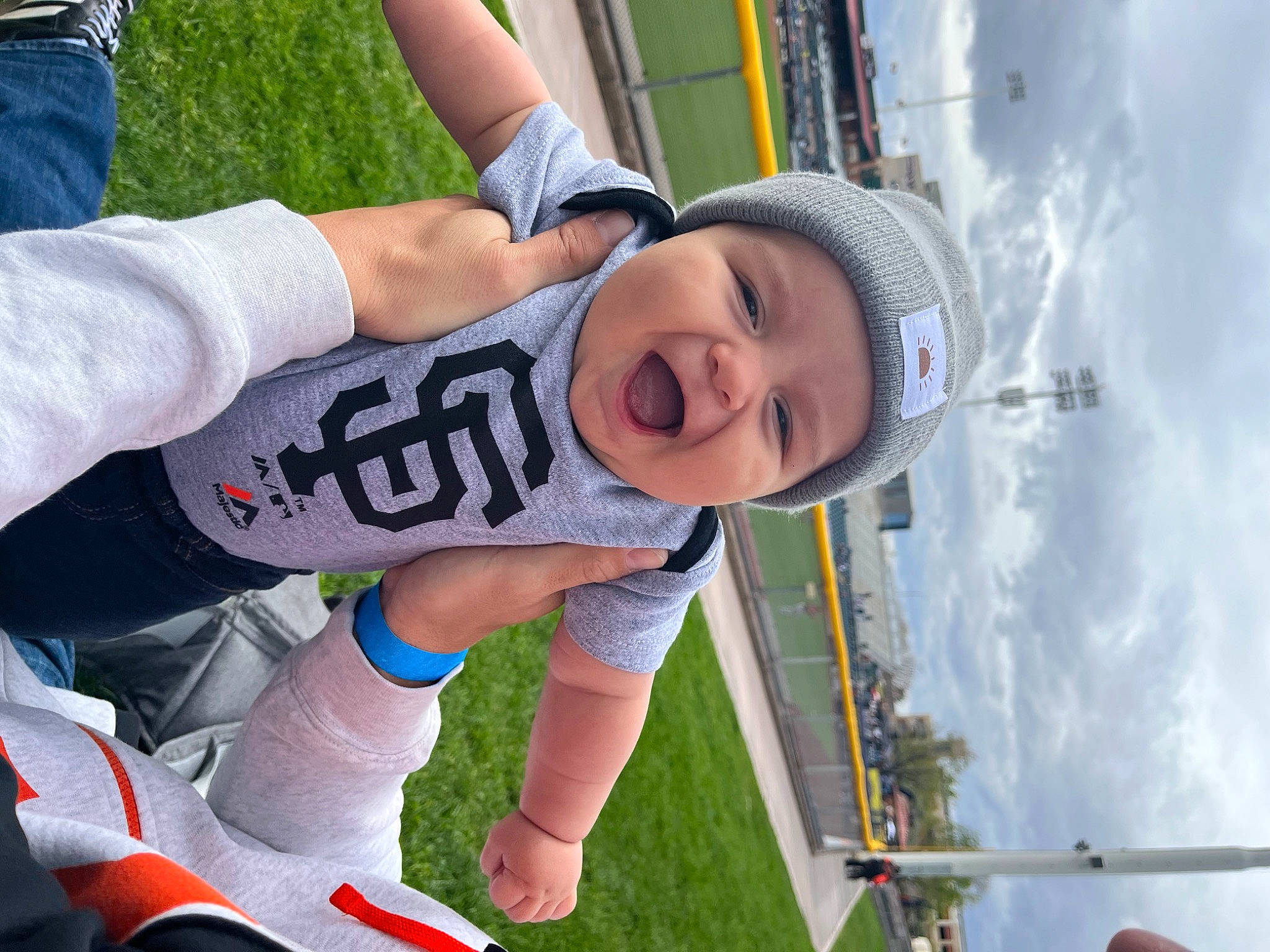 Noah is registered to the contest to win money with this photo: cloud, cool, fun, grass, happy, hat, headwear, jersey, leg, leisure, person, recreation, shorts, sky, smile, snapshot, sneakers, sports_gear, sports_uniform, thigh