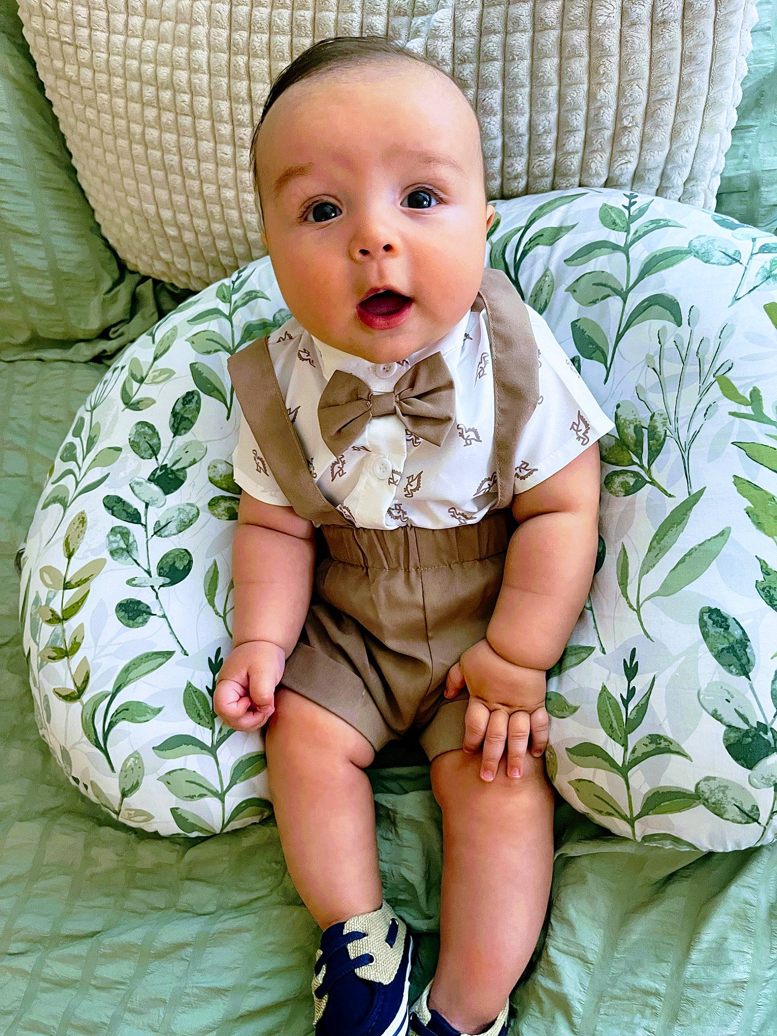 Noah is registered to the contest to win money with this photo: baby, baby_products, baby_toddler_clothing, chair, cheek, child, comfort, couch, eye, face, grass, iris, linens, pattern, person, sitting, skin, sleeve, surprise, textile