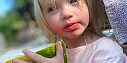 Troy joined the competition — help win amazing prizes! blonde_hair, blue_eyes, blurred_background, child, daylight, face, fruit, hand, holding, messy_face, nature, outdoor, person, pink_shirt, skin, snack, summer, toddler, towel, watermelon