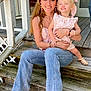 Troy is registered to the contest to win money with this photo: blonde_hair, boots, bracelets, casual_clothing, child, daylight, earrings, family, happy, holding, jeans, outdoor, pink_dress, porch, smiling, summer, sunlight, woman, wooden_railing, wooden_steps