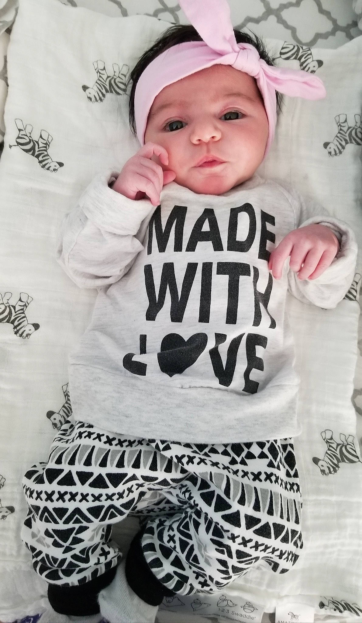 Audriana is registered to the contest to win money with this photo: baby, baby_bloomers, baby_products, baby_toddler_clothing, black_and_white, child, cool, font, headgear, headwear, pattern, person, photography, product, sleeve, smile, t_shirt, toddler, white