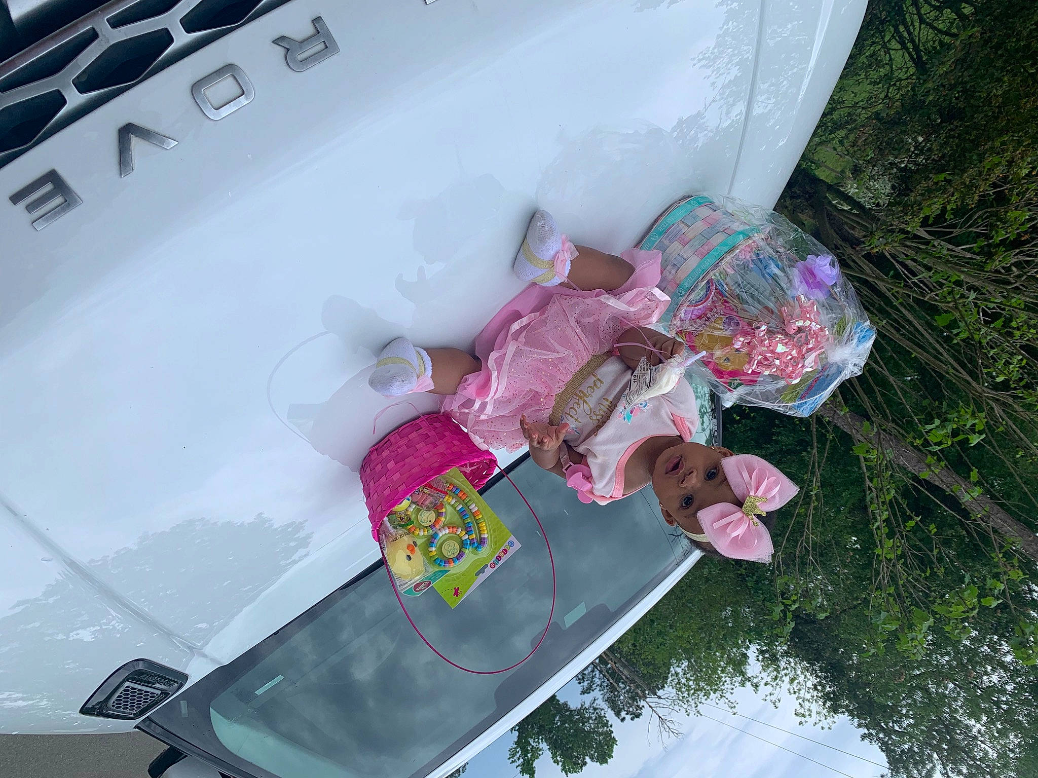 Aaliyah is registered to the contest to win money with this photo: automotive_design, automotive_exterior, bumper, family_car, fun, headwear, home_appliance, leisure, machine, magenta, motor_vehicle, person, pink, plant, smile, snapshot, tree, trunk, vehicle, vehicle_door