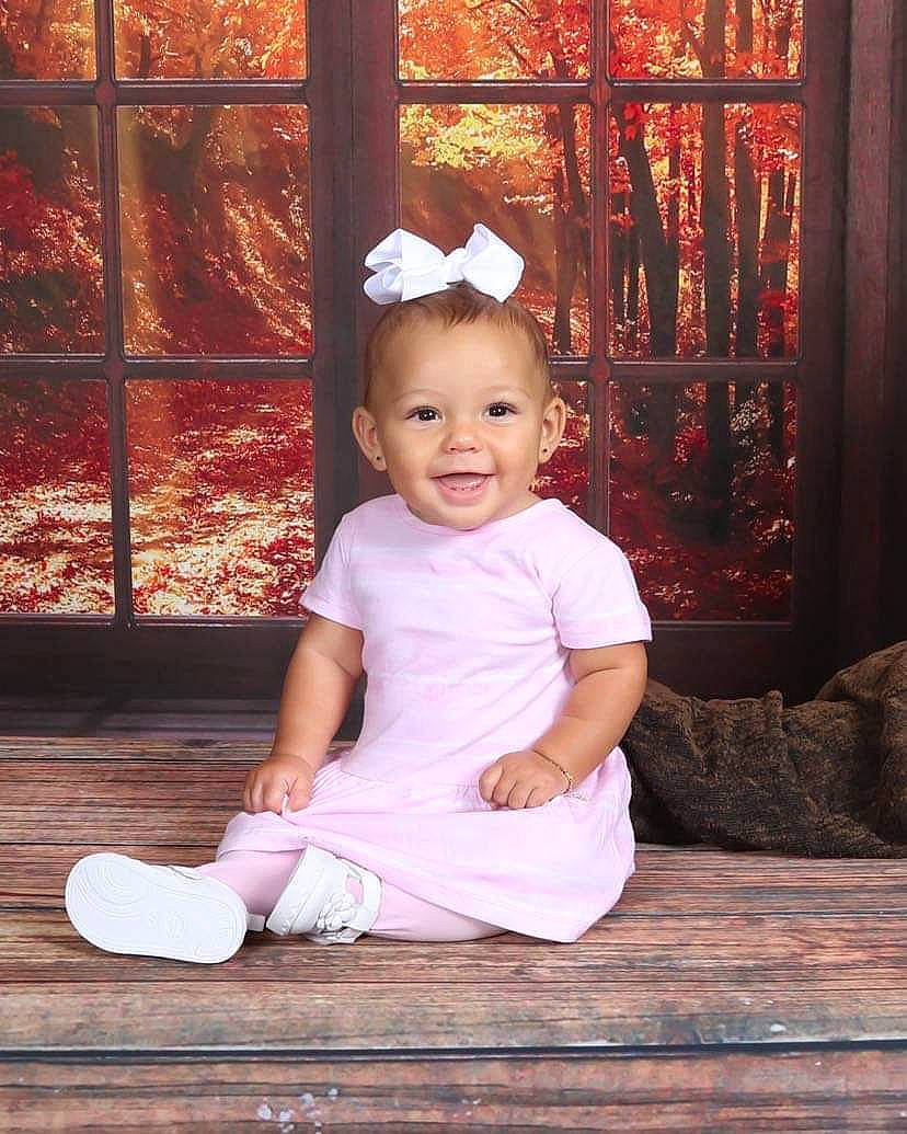 Raelle is registered to the contest to win money with this photo: baby, baby_toddler_clothing, child, clothing, face, flash_photography, flooring, fun, happy, hardwood, joy, magenta, person, pink, room, sitting, sleeve, smile, tints_and_shades, toddler
