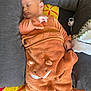 animal_face, baby, blanket, child, colorful, cozy, cushion, cute, fabric, face, gray, indoors, infant, orange, pattern, peaceful, rest, sleeping, soft, wrapped