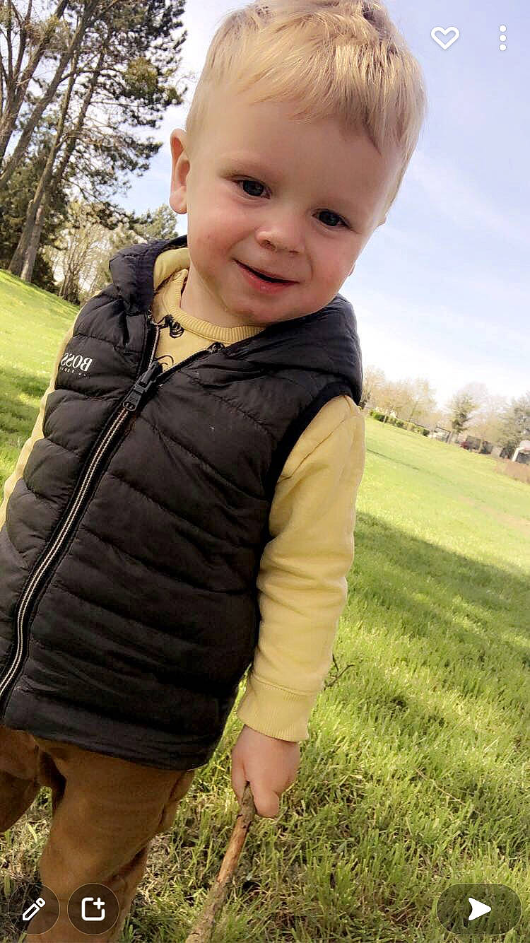 Tyler participe au concours pour gagner de l'argent avec cette photo : arm, baby, baby_toddler_clothing, face, grass, grassland, hair, happy, head, jacket, joy, people_in_nature, person, plant, skin, sky, sleeve, smile, standing, t_shirt