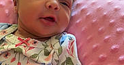 Ariannah joined the competition — help win amazing prizes! baby, closeup, comfort, cozy, cute, face, floral_clothing, gentle, hand, indoor, infant, newborn, person, pink_cushion, red_blanket, resting, skin, sleepy, small_hands, soft_texture
