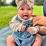 baby, child, tongue_out, headband, bow, denim_dress, sweater, hand, outdoor, grass, blanket, cute, smiling, happy, infant, person, portrait, sitting, nature, playful