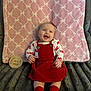 baby, infant, smiling, red_dress, red_socks, headband, blanket, pink_blanket, grey_blanket, wooden_sign, four_months, happy, sitting, cute, child, portrait, indoors, soft_texture, clothing, person