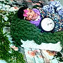 baby, infant, blanket, clock, floral, greenery, flowers, headband, pink_bow, cushion, wooden_floor, decorative, portrait, indoors, cute, resting, soft_texture, colorful, peaceful, young_child