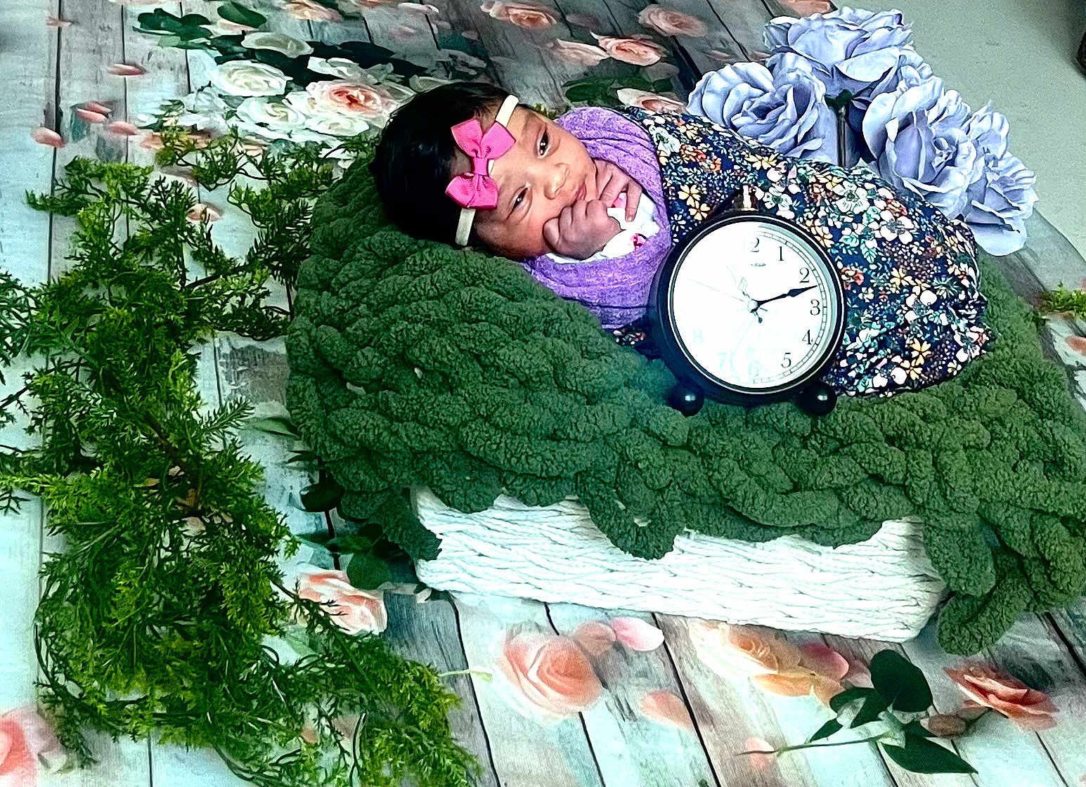 Estrella joined the competition — help win amazing prizes! baby, infant, blanket, clock, floral, greenery, flowers, headband, pink_bow, cushion, wooden_floor, decorative, portrait, indoors, cute, resting, soft_texture, colorful, peaceful, young_child