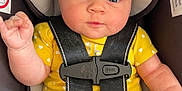 Charlotte is registered to the contest to win money with this photo: baby, infant, car_seat, yellow_bow, yellow_outfit, heart_pattern, blue_eyes, child, safety_harness, seatbelt, cute, portrait, infant_girl, car_interior, child_safety, closeup, pink_skin, hand_gesture, expression, newborn