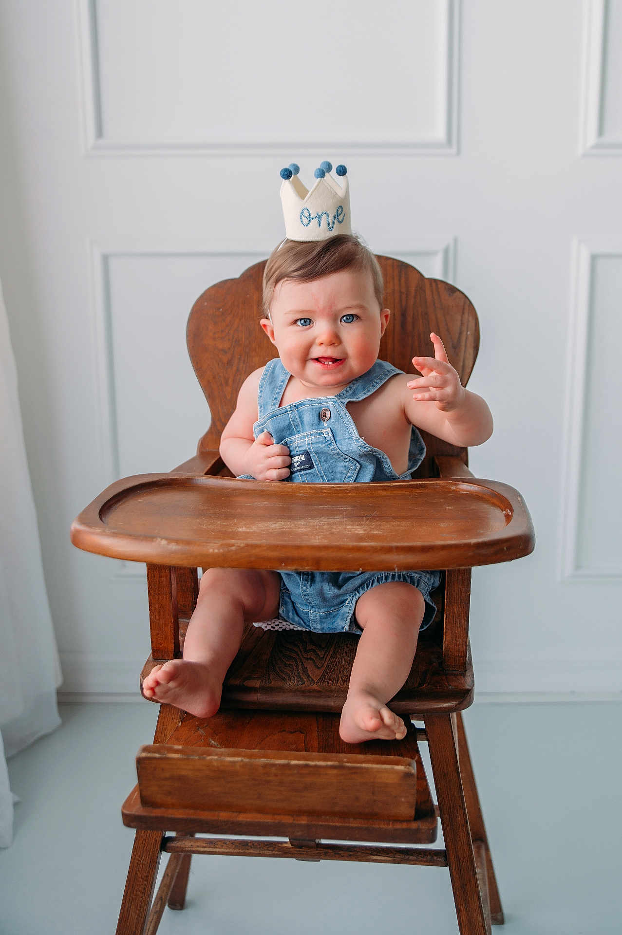 Braxton joined the competition — help win amazing prizes! baby, child, high_chair, denim, overalls, crown, one_year_old, smiling, blue_eyes, wooden_furniture, indoor, minimalist, cute, happy, portrait, infant, sitting, playful, light, casual