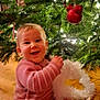 Agathe participe au concours pour gagner de l'argent avec cette photo : baby, celebration, cheerful, child, christmas_tree, cute, decorations, festive, garland, happy, holiday, indoors, infant, lights, ornaments, pink_onesie, seasonal, sitting, smiling, wooden_floor