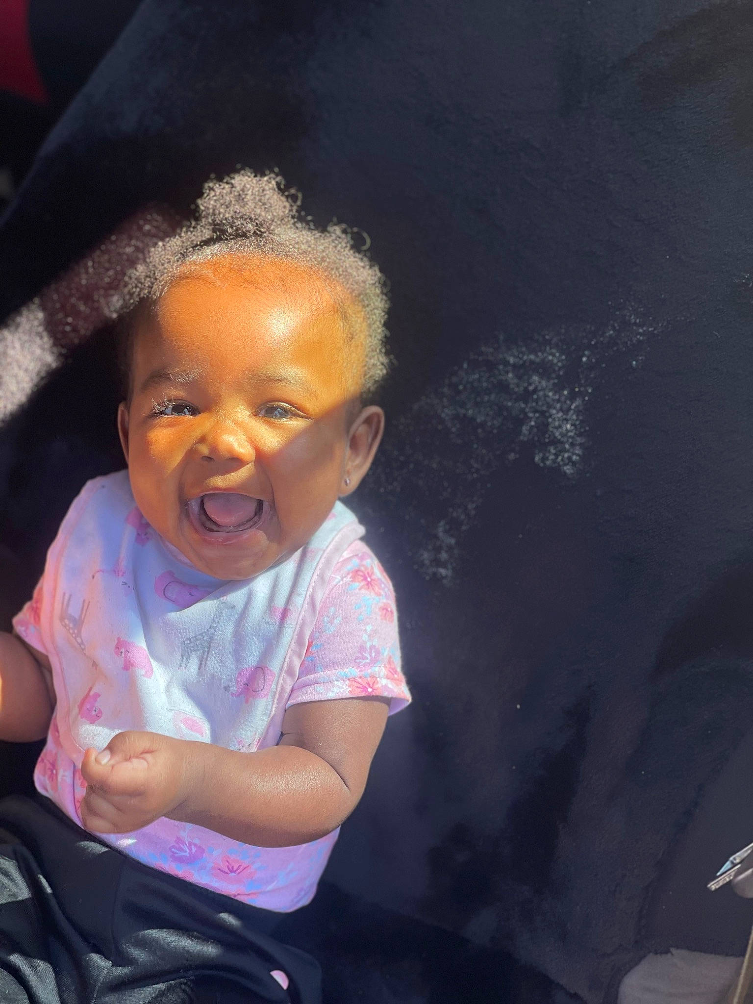 Koriana is registered to the contest to win money with this photo: afro, baby_toddler_clothing, black_hair, cheek, child, chin, cloud, flash_photography, gesture, happy, human_body, lip, nose, person, skin, smile, t_shirt, toddler, tree, water