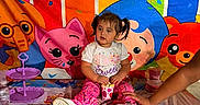 Diana joined the competition — help win amazing prizes! animal_theme, balloons, birthday, birthday_party, cake_stand, cartoon_characters, celebration, child, colorful, cupcake, decorations, indoors, party_table, pigtails, pink_pants, portrait, sitting, snack, toddler, white_shirt