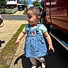 toddler, child, girl, portrait, outdoor, sunny, denim_overalls, minnie_mouse, hair_bow, ponytail, sandals, side_profile, standing, red_truck, vehicle, driveway, suburban, house, blue_sky, daylight
