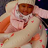 baby, infant, hat, knit_hat, pom_poms, bib, minnie_mouse, inflatable_seat, pink, candy_print, bear_print, heart_lights, smiling, cozy, indoors, child, cute, comfortable, person, playful