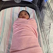 Imani joined the competition — help win amazing prizes! newborn, baby, swaddled, pink_blanket, hospital_bassinet, sleeping, infant, striped_blanket, hospital, bed, peaceful, cute, person, face, resting, soft_texture, indoors, newborn_care, medical_equipment, blanket