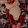 Imani joined the competition — help win amazing prizes! baby, infant, onesie, headband, pink_socks, bed, pillow, floral_pattern, heart_filter, lying_down, cute, child, portrait, indoors, blanket, sleepwear, smiling, person, young_child, soft_lighting