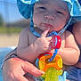 baby, baseballcap, bodypart, cap, clothing, face, finger, hand, hat, head, lifejacket, person, photography, pool, portrait, summer, sunhat, swimwear, vest, water