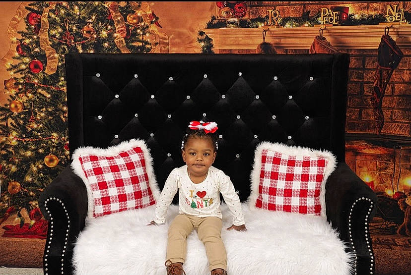 Kinsley joined the competition — help win amazing prizes! baby_toddler_clothing, boot, child_model, christmas, christmas_decoration, christmas_eve, christmas_lights, costume_accessory, costume_hat, cushion, decoration, holiday, interior_design, living_room, ornament, person, pillow, sock, textile, throw_pillow