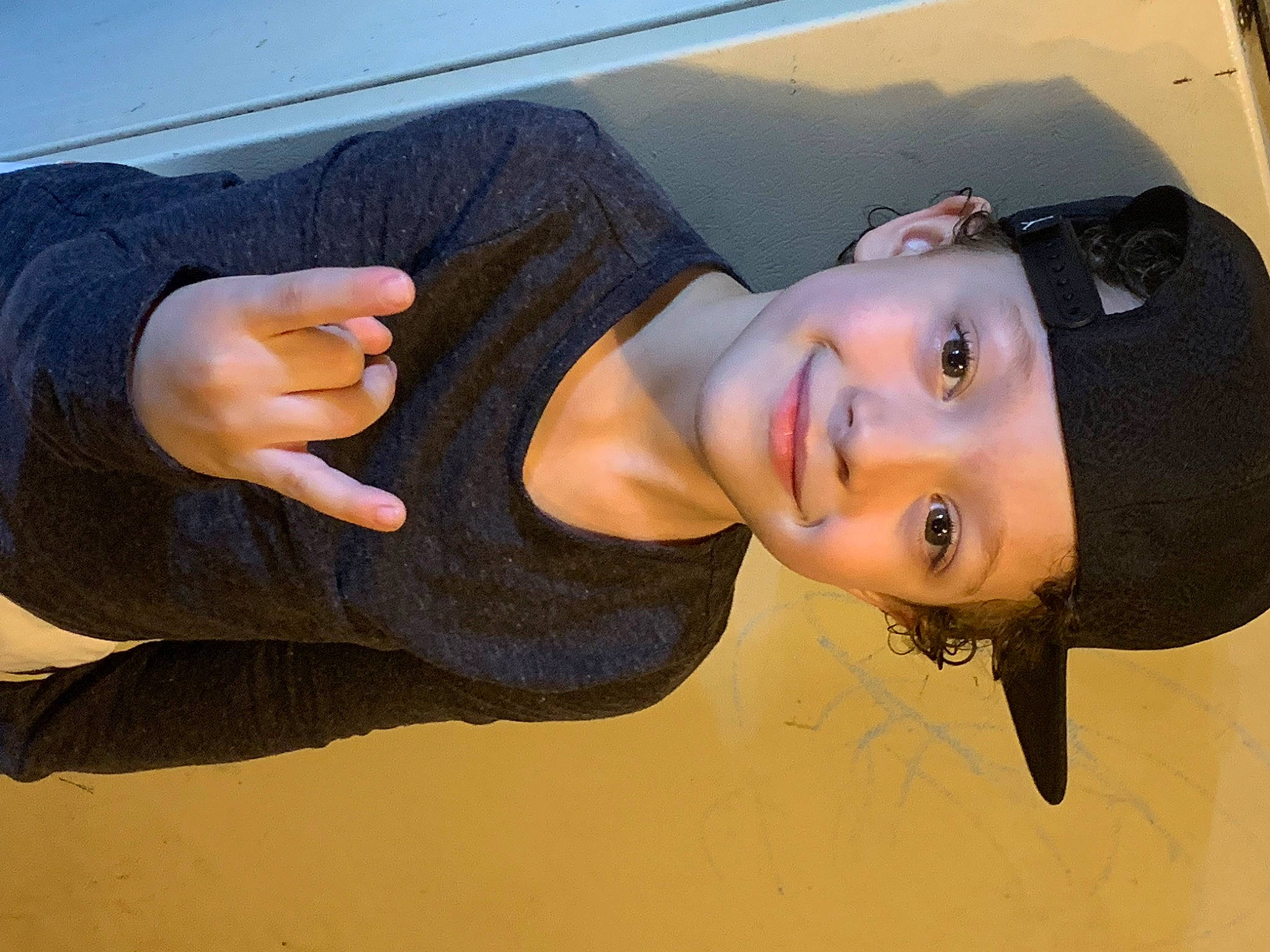 Dawson is registered to the contest to win money with this photo: arm, black_hair, denim, elbow, eyewear, flash_photography, gesture, happy, headwear, human_leg, joy, landscape, lip, long_hair, mouth, neck, person, smile, street_fashion, t_shirt