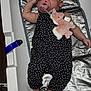 Anya Madison is registered to the contest to win money with this photo: baby, infant, pacifier, headband, bow, polka_dot, plush_toy, sleeping, mat, changing_station, black_clothing, white_bow, soft_toy, hand, foot, skin, indoor, cute, resting, child
