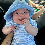 Kaisyn is registered to the contest to win money with this photo: baby, child, smiling, blue_towel, striped_onesie, hand, car_interior, tattoo, person, happy, cute, infant, holding, face, skin, arm, seat, portrait, baby_fashion, joy