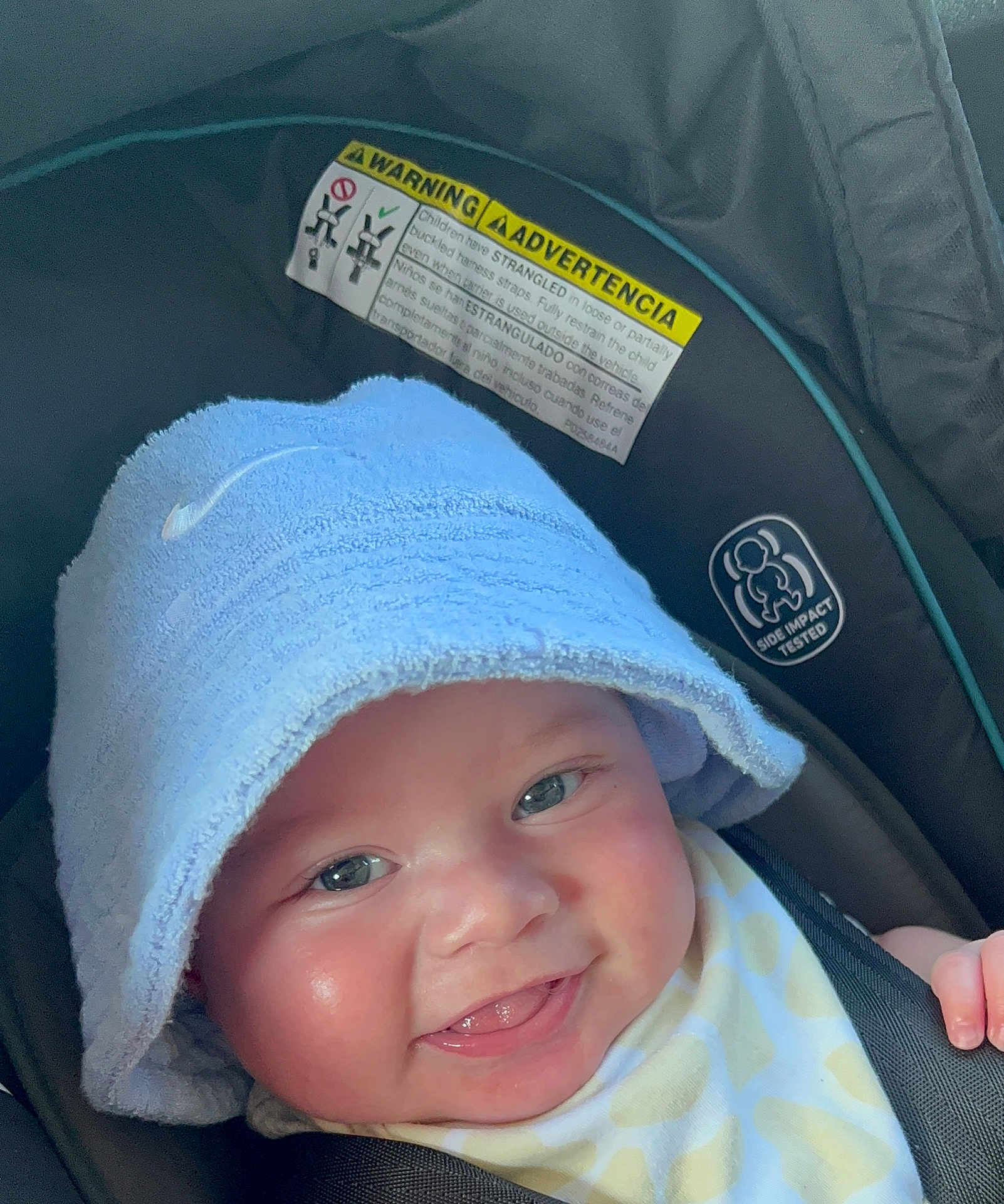 Kaisyn joined the competition — help win amazing prizes! baby, smile, face, towel, hat, car_seat, safety_harness, child, infant, closeup, happy, cute, skin, eyes, mouth, tongue, clothing, seatbelt, headwear, indoor