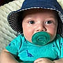 Kaisyn joined the competition — help win amazing prizes! baby, infant, pacifier, hat, bucket_hat, blue_eyes, dinosaur_print, turquoise_shirt, clothing, hands, cute, child, portrait, closeup, skin, infancy, face, young_child, indoors, cozy