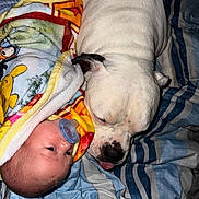 Jack is registered to the contest to win money with this photo: baby, pacifier, blanket, dog, white_dog, bedspread, striped_bedspread, resting, snuggling, cozy, face, closeup, indoor, sleepy_dog, curious_baby, animal, child, pet, cute, warm