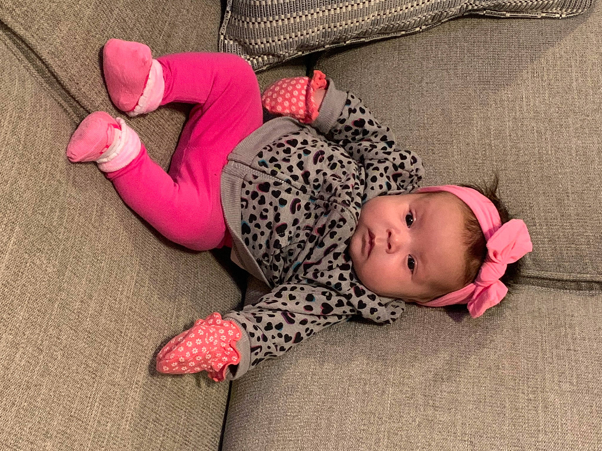 Sierra is registered to the contest to win money with this photo: arm, baby, baby_toddler_clothing, comfort, finger, floor, flooring, hand, headgear, human_body, joint, knee, leg, pattern, person, pink, sleeve, textile, thigh, toddler