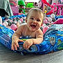 Anna participe au concours pour gagner de l'argent avec cette photo : baby, child, indoor, playroom, toys, inflatable_pool, ball_pit, pink_balls, gray_balls, white_balls, smiling, happy, floor, play, fun, cute, infant, furniture, slide, plastic_balls