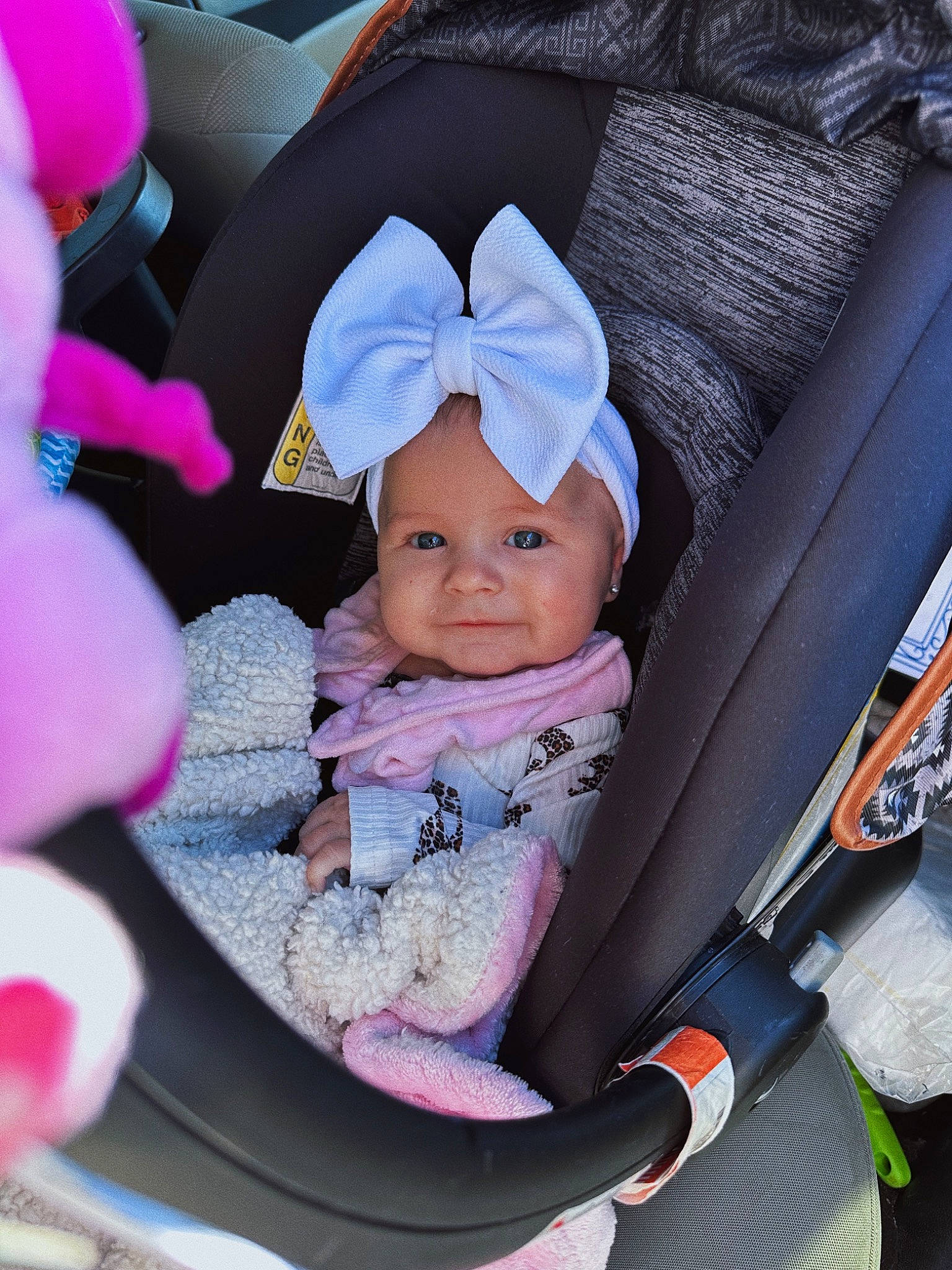 Kodie is registered to the contest to win money with this photo: auto_part, baby, baby_carriage, baby_products, baby_safety, baby_toddler_clothing, car_seat, child, comfort, fun, hat, headwear, lap, person, product, purple, sitting, toddler, violet, white
